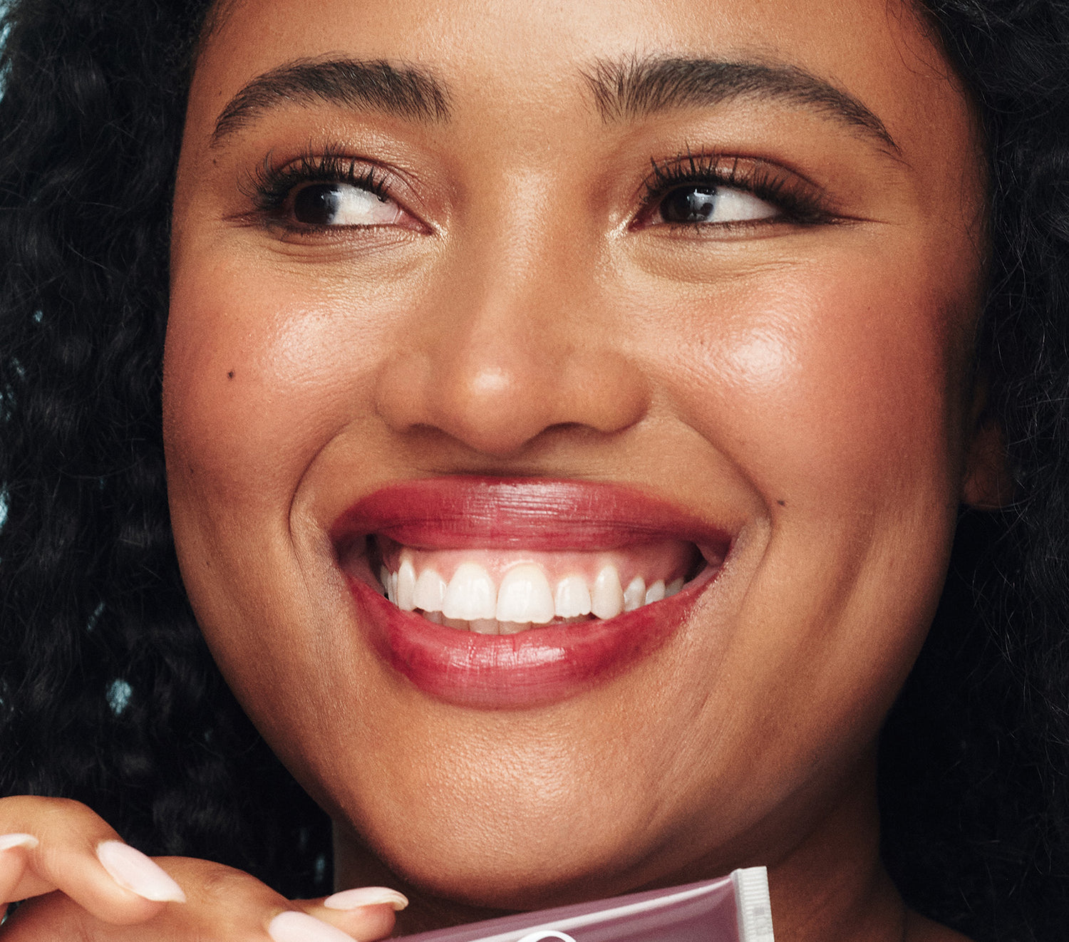 Model wearing the Lanolips Tinted Lip Balm in Spice on her lips - a lanolin rich lip moisturiser. Spice, a rich plum shade inspired by the 90s, delivers a wine-stained look with deep hydration instead of the hangover. Designed in Australia, and made in the UK with Australian and New Zealand lanolin, this 98.8% natural formula is packed lanolin, vitamin e and shea butter. With just 1% tint, this ultra wearable balm enhances the lips' natural beauty - so good, you'll want to throw away your lipstick.