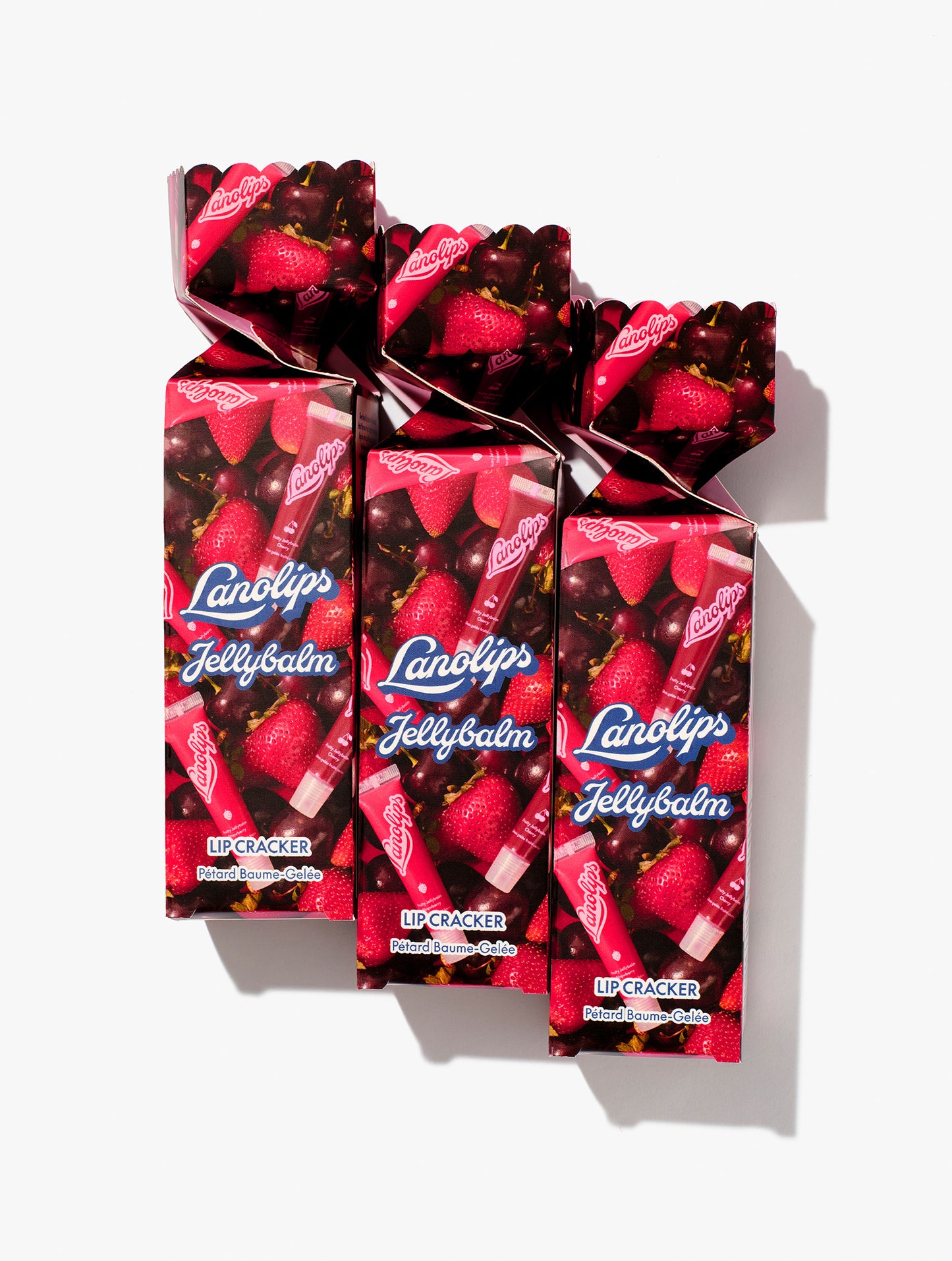 Lifestyle shot of the Lanolips Jellybalm Lip Cracker comes in two of the fruitiest lip tints - Jellybalm Strawberry and Jellybalm Cherry.