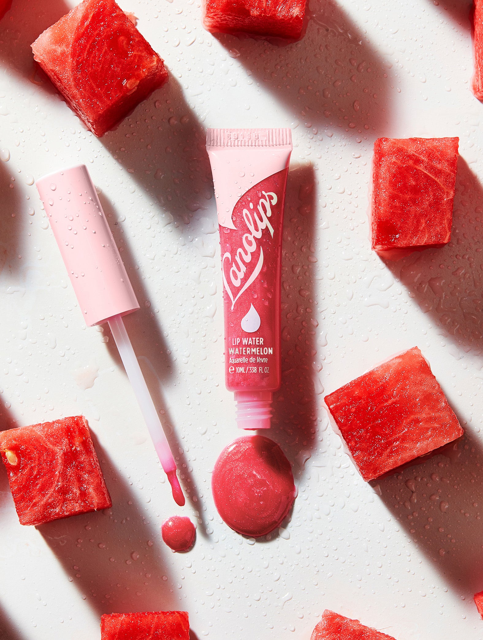 Lanolips Lip Water Watermelon is a transparent watermelon-pink holographic shimmer - for watermelon juice-tasting lips that are both hydrated and glowing.
