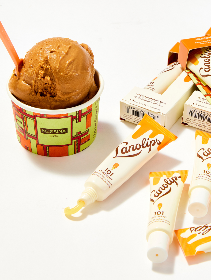 Flat lay featuring Lanolips 101 Ointment Multi-Balm in Dulce de Leche Gelato Messina ice cream tub. Surrounded by balm tubes and boxes, this sweet collab is hydration meets dessert. When the World's Best Lip Balm met the World's Best Gelato - irresistible, iconic, and deliciously hydrating.