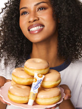 Load image into Gallery viewer, Model holding the Lanolips 101 Ointment Glazed Donut
