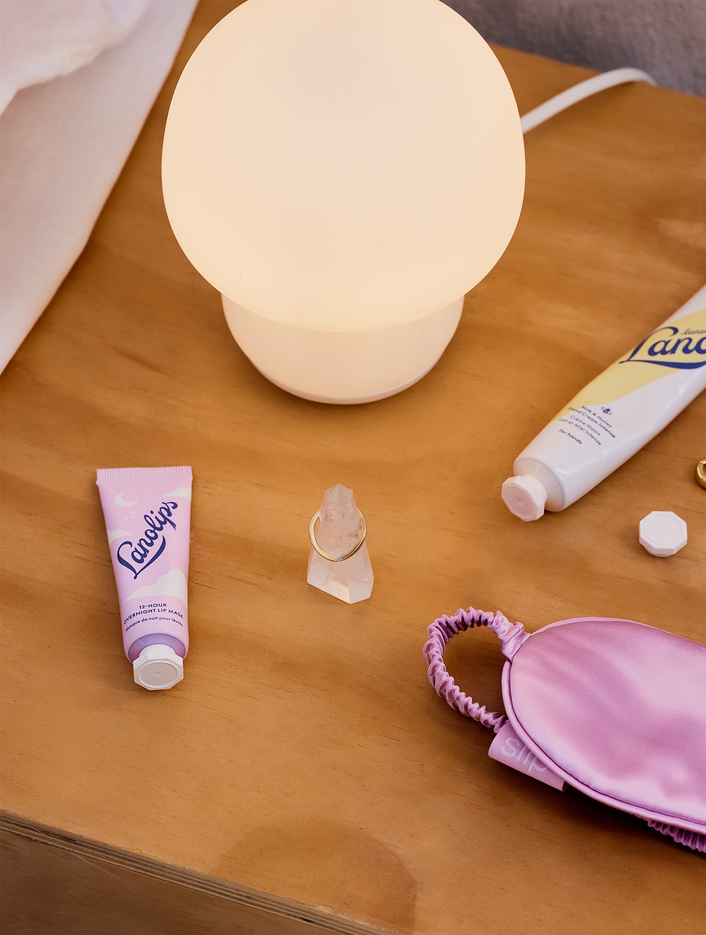 Lifestyle products around the Lanolips 12 Hour Overnight Lip Mask range, including the Lanolips Milk & Honey Hand Cream Intense. 