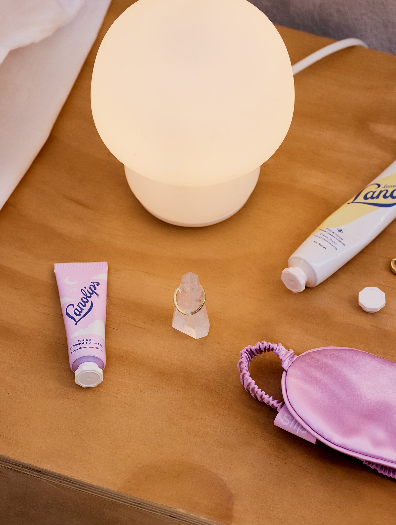 Lifestyle products around the Lanolips 12 Hour Overnight Lip Mask range, including the Lanolips Milk & Honey Hand Cream Intense. 