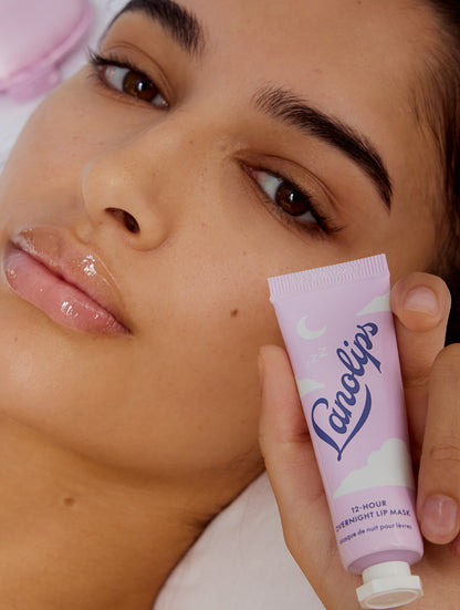 Model holding up Lanolips 12 Hour Overnight Lip Mask. 