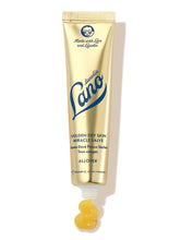 Load image into Gallery viewer, Lanolips Golden Dry Skin Miracle Salve 25g comes in a metallic gold squeezable tube with a white cap. The packaging features the Lano logo in deep blue lettering, along with ‘Made with Love and Lanolin’ inscribed at the top. A small amount of the rich, golden balm is shown oozing from the tube, emphasising its ultra-hydrating, multi-purpose formula designed to deeply nourish and repair very dry skin, hands, and rough patches.
