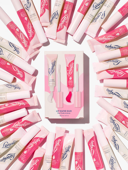 Still shot of Lanolips Lanolin Lip Water Duo surrounded by tubes of Liquid Lanolin Lip Water and Lip Water Watermelon. Fantastic for the gift giving season. 