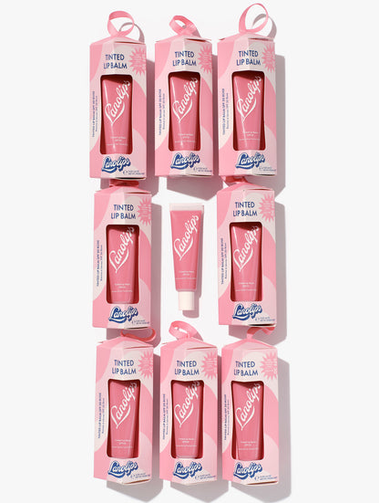 Multiple boxes of Lanolips Tinted Lanolin Lip Balm SPF 30 in Rose on a white background. Now in a bauble for the perfect holiday gift-giving. 