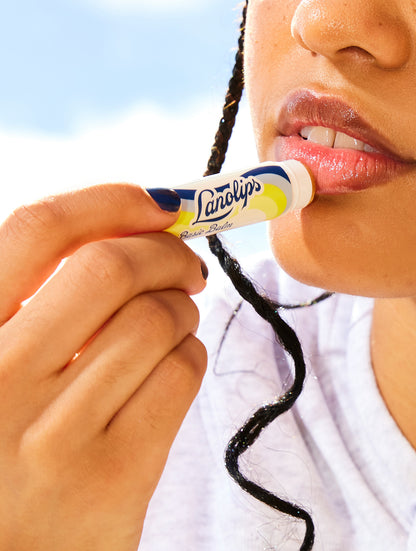 Model applying Lanolips Basic Balm Vanilla.