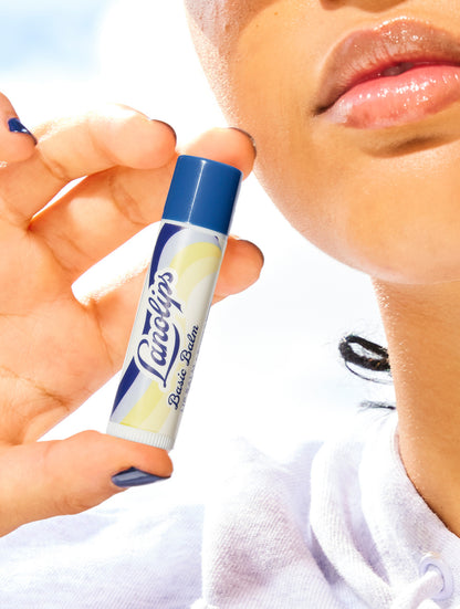 Model holding the Lanolips Basic Balm Original Vanilla. 