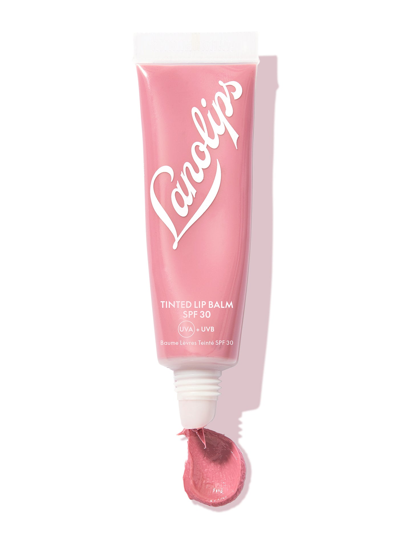 Squeezed still shot of Lanolips Tinted Lip Balm SPF 30 in Rose: A dusty, creamy pink that give your lips a healthy glow.