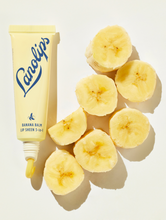 Load image into Gallery viewer, Lifestyle shot of Lanolips Banana Balm Lip Sheen 3-in-1 with cut up bananas
