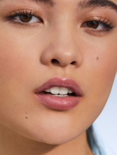 Load image into Gallery viewer, Model with Tinted Lip Balm in Rose, a creamy rose-tea sheen.
